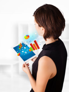 http://www.dreamstime.com/stock-photo-young-woman-looking-modern-tablet-colourful-diagrams-business-image32069960