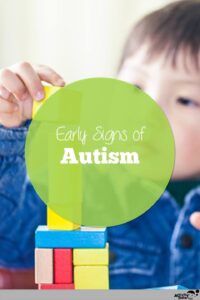 young boy with autism building with blocks