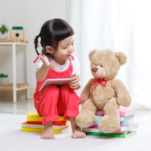 little-girl-reading-to-stuffed-animal-epilepsy